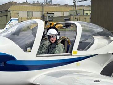 Year 9 student Johnny sitting in a plane with a Royal Navy Flying Instructor