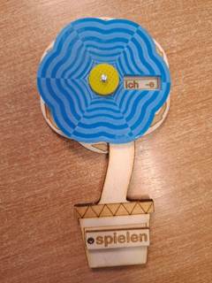 A wooden tool for learning conjugations of German Verbs in the shape of  flower