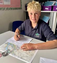 Hope Valley College student preparing for a practice expedition using a map and compass