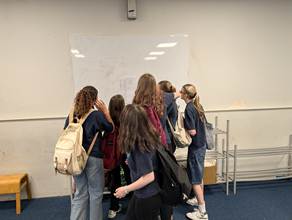 A group of students looking at the cast list for HVC's upcoming production of Frozen