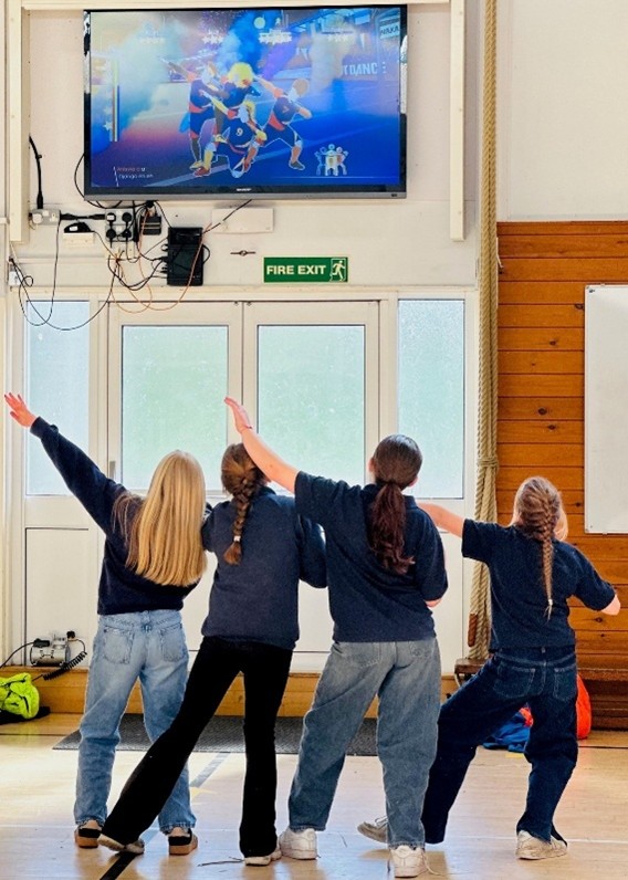 Four students taking part in Just Dance club